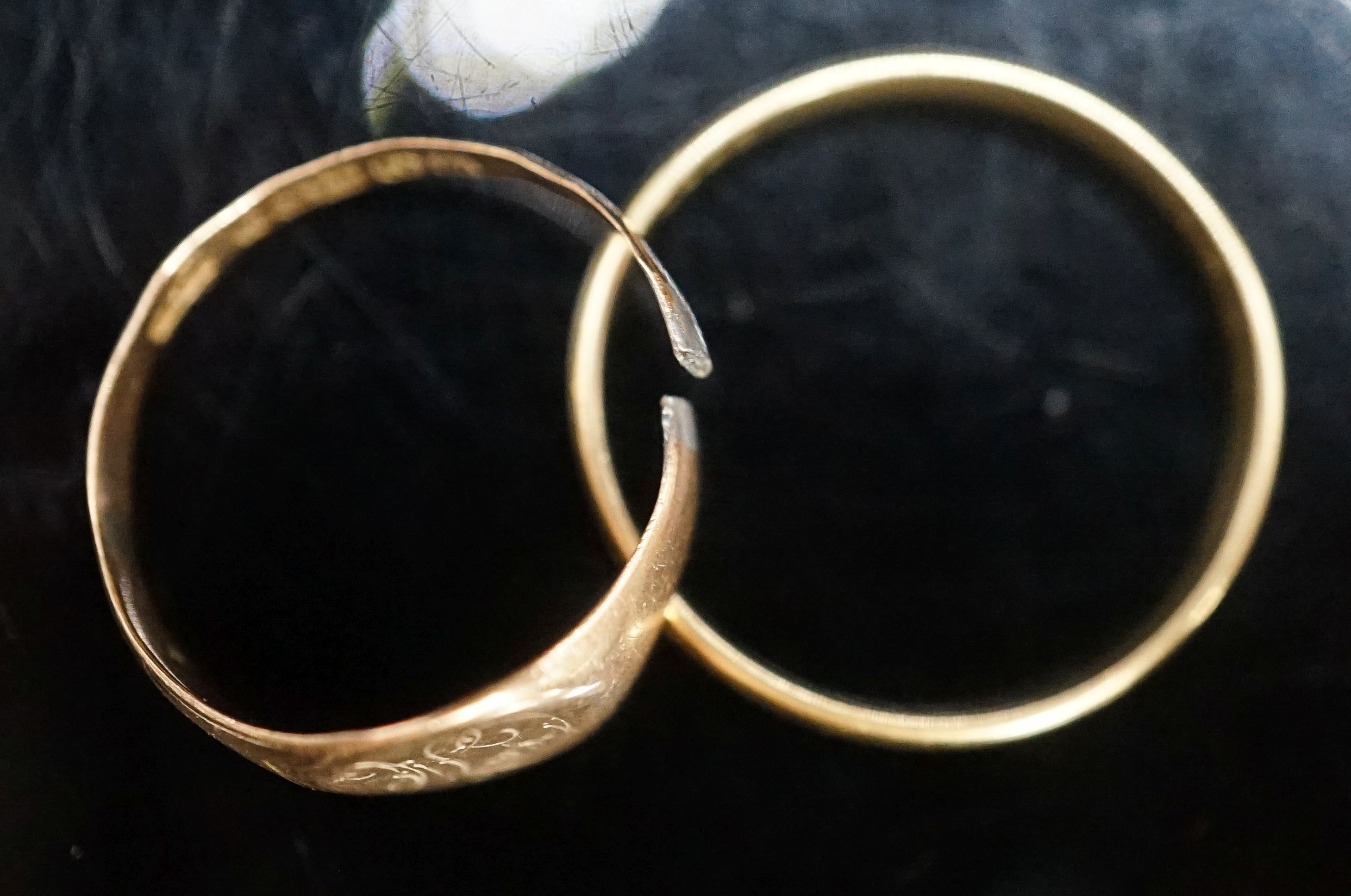 An 18ct gold wedding band, 2.1 grams and a 9ct gold signet ring (cut) 1.7 grams.